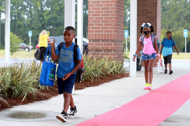 Students arrive Tuesday morning for the first day of school at McAllister Elementary School in Richmond Hill.