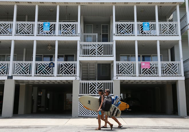 Signs on balconies of these Tybee Island condos identify units that are available as vacation rentals.