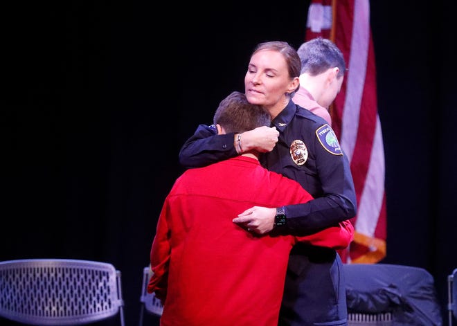 Tybee Island police chief Tiffany Hayes gets a hug from her son after officially being sworn in on Friday January 13, 2023 at the Tybee Post Theater.